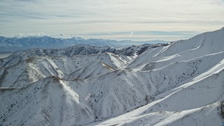 AX125_122 - 5.5K aerial stock footage of snow on steep ridges in the Oquirrh Mountains, Utah