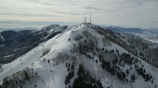 AX125_133 - 5.5K aerial stock footage orbit radio towers on Farnsworth Peak's summit with winter snow in Utah