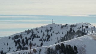 AX125_143 - 5.5K aerial stock footage of radio towers on the summit of Nelson Peak in Utah