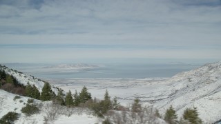 AX125_156 - 5.5K aerial stock footage of the Oquirrh Mountains and a view of Great Salt Lake, Utah