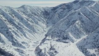 AX125_166 - 5.5K aerial stock footage of a solitary building in Baltimore Gulch with winter snow, Utah
