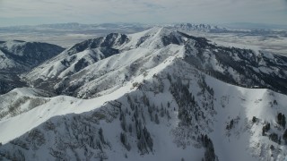 AX125_208 - 5.5K aerial stock footage orbiting Rocky Peak with fresh winter snow in Utah's Oquirrh Mountains