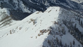 AX125_209 - 5.5K aerial stock footage orbit snowy summit of Rocky Peak in wintertime, Oquirrh Mountains, Utah