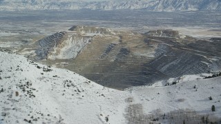 AX125_227 - 5.5K aerial stock footage approach the Bingham Canyon Mine in winter, Utah