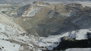 AX125_228 - 5.5K aerial stock footage of approaching Bingham Canyon Mine with light winter snow, Utah