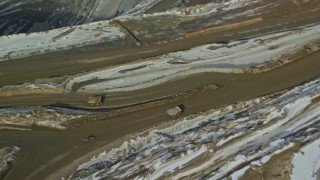 AX125_236 - 5.5K aerial stock footage orbit above gravel hauler at Bingham Canyon Mine in winter, Utah
