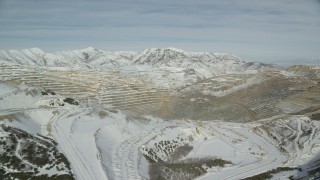 AX125_254 - 5.5K aerial stock footage of Bingham Canyon Mine with winter snow in Utah