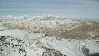 AX125_254E - 5.5K aerial stock footage of Bingham Canyon Mine with winter snow in Utah
