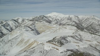 AX125_272 - 5.5K aerial stock footage orbit tiers cut out of the side of a a slope in the Oquirrh Mountains, Utah