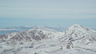 AX125_314 - 5.5K aerial stock footage of snowy peaks on Antelope Island in Utah