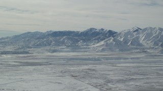 AX125_317 - 5.5K aerial stock footage of white snow on the Oquirrh Mountains in winter, Utah