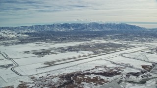 AX125_324 - 5.5K aerial stock footage of Salt Lake City International Airport in Utah with winter snow