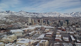AX126_011E - 5.5K aerial stock footage of flying by Downtown Salt Lake City with snow on the ground in winter, Utah
