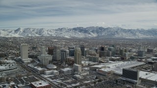 AX126_013 - 5.5K stock footage aerial video orbit of Downtown Salt Lake City buildings with light winter snow, Utah