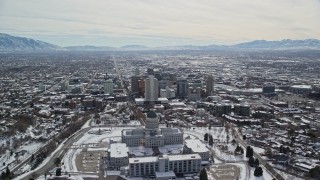 AX126_016E - 5.5K aerial stock footage orbiting Downtown Salt Lake City and Utah State Capitol Building with winter snow