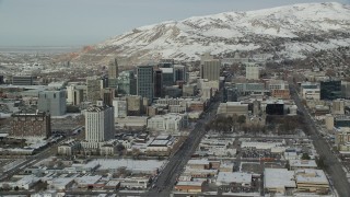 AX126_024 - 5.5K stock footage aerial video orbit south side of Downtown Salt Lake City with winter snow, Utah