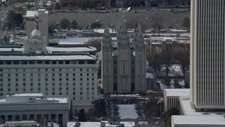 AX126_043 - 5.5K stock footage aerial video orbit the Salt Lake Temple in downtown with winter snow, Utah