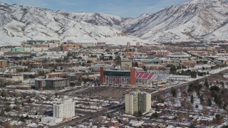 AX126_046E - 5.5K aerial stock footage of the University of Utah campus near Rice-Eccles Stadium with winter snow, Salt Lake City, Utah