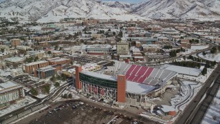 AX126_048E - 5.5K aerial stock footage fly over Rice-Eccles Stadium and University of Utah buildings with winter snow, Salt Lake City