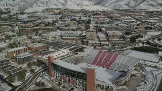 AX126_049 - 5.5K stock footage aerial video fly over Rice-Eccles Stadium and University of Utah buildings with winter snow, Salt Lake City
