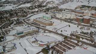 AX126_051 - 5.5K aerial stock footage orbit baseball field and campus buildings with snow at University of Utah, Salt Lake City