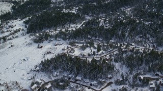 AX126_088 - 5.5K aerial stock footage orbit upscale homes and evergreen trees covered in winter snow in Park City, Utah