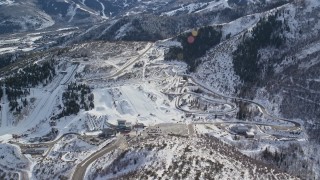 AX126_095E - 5.5K aerial stock footage of Utah Olympic Park with winter snow in Park City, Utah
