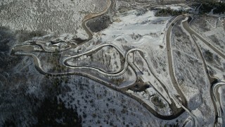 AX126_104 - 5.5K stock footage aerial video of circling the tracks for luge and bobsled events at Utah Olympic Park with winter snow, Park City