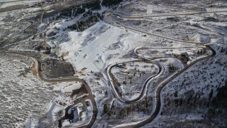 AX126_105 - 5.5K aerial stock footage circle above the luge and bobsled track at Utah Olympic Park in winter, Park City