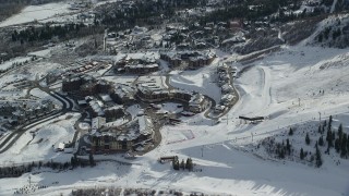 AX126_110 - 5.5K aerial stock footage orbit Canyons Resort in Park City with winter snow in Utah