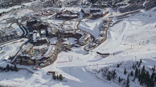 AX126_110E - 5.5K aerial stock footage of Canyons Resort in Park City with winter snow in Utah