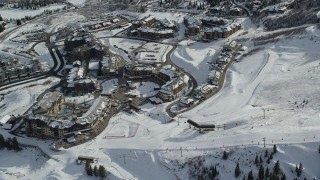 AX126_111 - 5.5K aerial stock footage orbit ski slopes, ski lifts and Canyons Resort hotels with winter snow, Park City, Utah