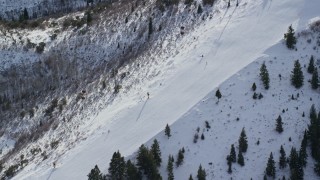 AX126_112 - 5.5K aerial stock footage of bird's eye view of skiers on a slope at Canyons Resort in Park City, Utah