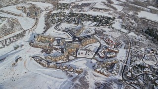 AX126_113E - 5.5K aerial stock footage orbiting hotels at Canyons Resort in Park City in wintertime, Utah