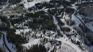 AX126_119 - 5.5K aerial stock footage fly over mountainside mansions with winter snow in Park City, Utah