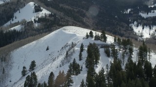 AX126_121 - 5.5K aerial stock footage orbit gondolas at the summit of a snowy mountain in winter, Park City, Utah