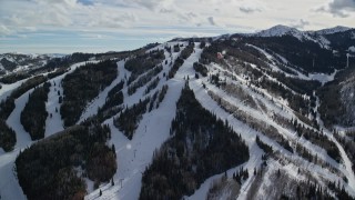 AX126_124 - 5.5K aerial stock footage orbit a ski lift and snowy runs at Park City Mountain Resort, Utah