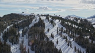 AX126_132 - 5.5K aerial stock footage orbit ski lifts and slopes at Deer Valley Ski Resort with winter snow, Utah