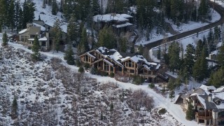 AX126_138 - 5.5K aerial stock footage orbit Deer Valley mansion with winter snow in Utah