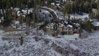 AX126_139E - 5.5K aerial stock footage of Deer Valley mansion with winter snow in Utah