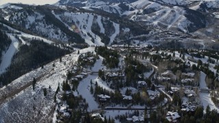 AX126_142E - 5.5K aerial stock footage of mountaintop Deer Valley mansions with winter snow in Utah