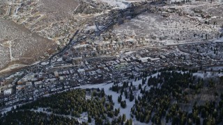 AX126_167E - 5.5K aerial stock footage of flying by the small mountain town of Park City in wintertime, Utah