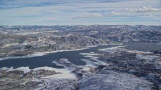 AX126_176 - 5.5K aerial stock footage approach Jordanelle Reservoir near Heber City with winter snow, Utah