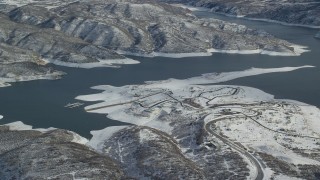 AX126_179 - 5.5K aerial stock footage orbit roads near the shore of Jordanelle Reservoir in winter, Heber City, Utah