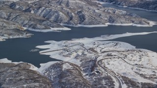 AX126_179E - 5.5K aerial stock footage of roads near the shore of Jordanelle Reservoir in winter, Heber City, Utah