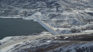 AX126_181 - 5.5K aerial stock footage orbit dam on the Jordanelle Reservoir in wintertime, Heber City, Utah