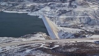 AX126_181E - 5.5K aerial stock footage orbit dam on the Jordanelle Reservoir in wintertime, Heber City, Utah