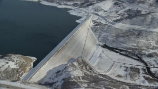 AX126_184 - 5.5K aerial stock footage of circling the Jordanelle Dam with light winter snow near Heber City, Utah