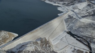 AX126_185 - 5.5K stock footage aerial video orbit of the Jordanelle Dam near Heber City in winter, Utah
