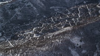 AX126_203 - 5.5K aerial stock footage approach rural small town homes with winter snow in Midway, Utah